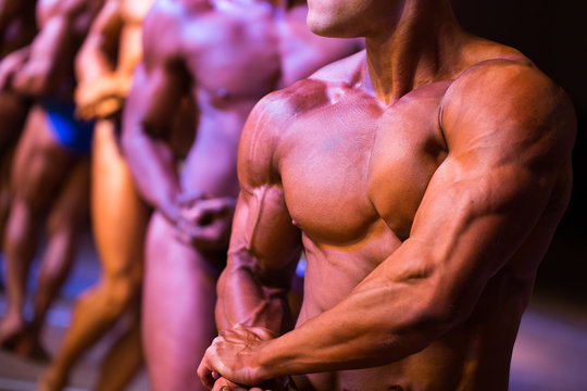athletes bodybuilders are straining biceps side of arm