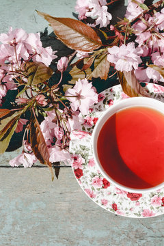 Beautiful, vintage teacup with Japanese cherry tree blossoms, shot from above.