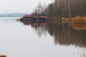 Fototapeta premium Sinking boat station building on a Yanov backwater in Pripyat city, Chernobyl Exclusion Zone, Ukraine