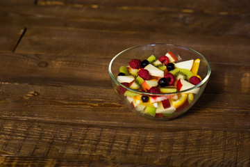 Delicious fruits salad in plate on table close-up
