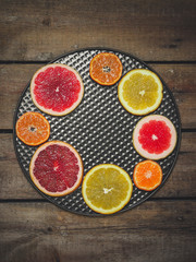 slices of different varieties of citrus fruits on the table (background)
