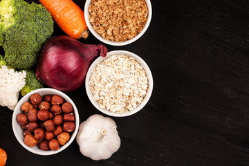 Fresh raw vegetables with nuts and cereals for cooking or eating. Vegetarian food. Top view