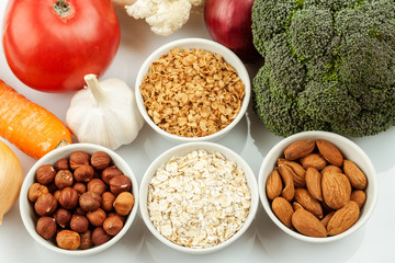Fresh raw vegetables with nuts and cereals for cooking or eating. Vegetarian food. Top view