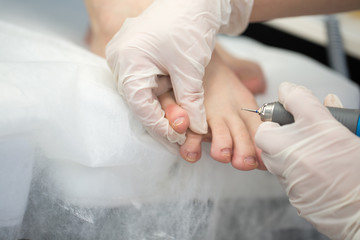 Obraz na płótnie Canvas Professional pedicure master making pedicure in salon