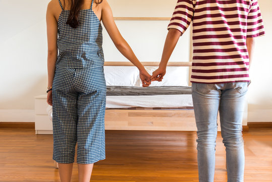 Men and women stand hand in front of the bed on Valentine's Day.