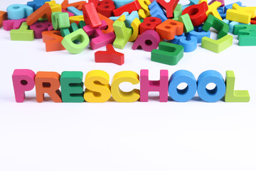 Preschool word block with colorful alphabtes and numbers in background