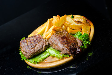 Plate with delicious steak and fries, closeup