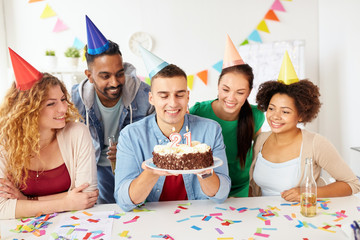 team greeting colleague at office birthday party