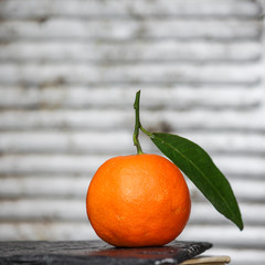 mandarin with green leaf on the table (background) tangerines