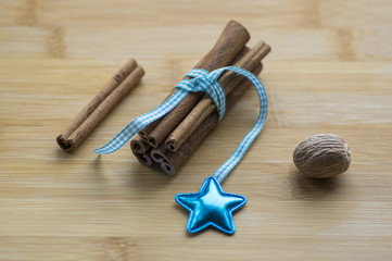 Group of cinnamon tied with checkered light blue bow, blue star