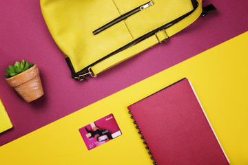 Bag, flowers and other womens accessories by color and the bright background. The view from the top. Flat lay.