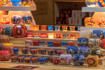 Beautiful colorful candlelights with attractive designs offered at a booth on a Christmas market. Concept: holidays, christmas