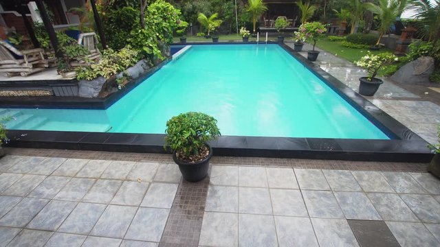 Luxurious open air swimming pool at resort. Swimming pool with turquoise water in a luxury hotel. 4k.Travel concept.