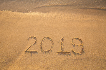The inscription on the sand in 2019, which washes off a wave.