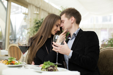 Beautiful young couple kissing in restaurant