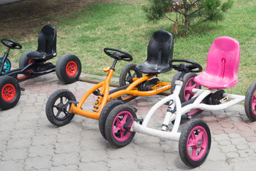 Child's colorful four-wheeled bicycles in the park