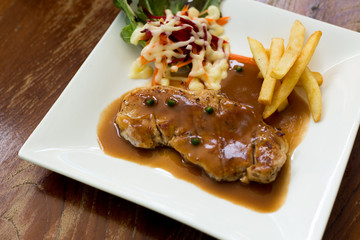Grilled beef steak with french fries and broccoli