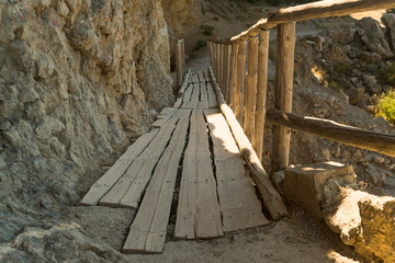 Wooden bridge in the mountains on the precipice