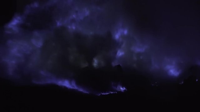Blue fire of burning sulfur in a crater of a volcano Kawah ijen, Java, Indonesia. Famous tourist attraction, where sulfur is mined. Ijen volcano complex is a group of stratovolcanoes in the Banyuwangi