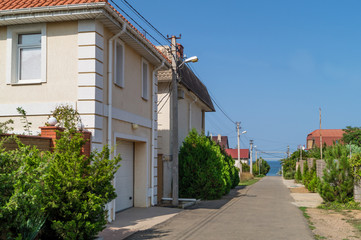 Street in a cottage village by the sea at summer