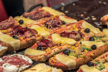 Tasty and freshly prepared baguette at a market, festival or at a stall. Concept: food