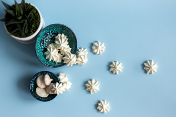 Meringue on blue paper, natural light selective focus