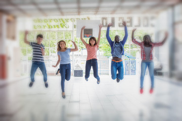 Obraz premium International multi ethnic group of happy smiling boys and girls jumping in school courtyard