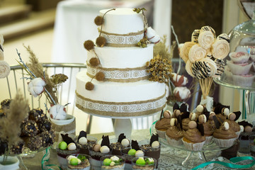 Wedding cake with cupcakes at the exhibition