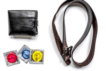 male contraception for safe sex with condoms and wallet on white