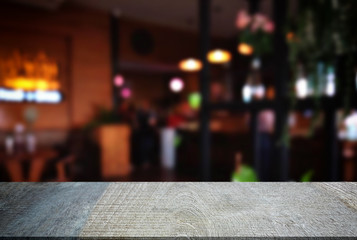 Empty wooden table and blurred background of abstract in front of restaurant or coffee shop for display of product or for montage