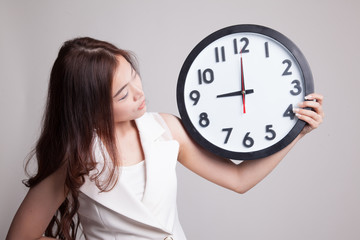 Young Asian woman with a clock.