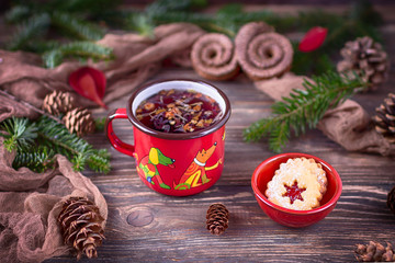 Fruit tea and Christmas cookies in a ceramic bowl on a Christmas background