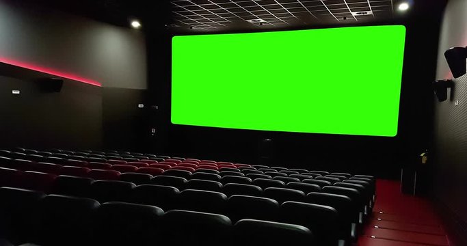 cinema interior of movie theatre with empty red seats with copyspace on the chroma key green screen and glow on edge, concept of recreation and entertainment