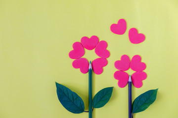 Red heart flower on yellow background with copy space for your text. Concept for valentine's day celebration or couple of love.
