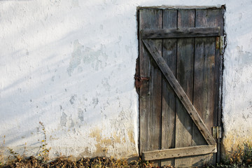 Old wooden door in an old stone wall