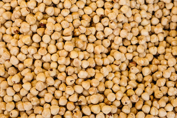 Roasted hazelnuts or filberts nuts heap, texture background, top view.