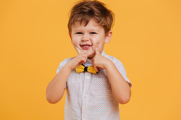 Cheerful little boy child standing isolated