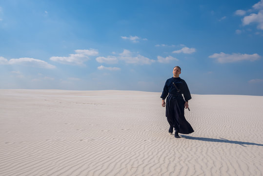 Concentrated man is walking through the desert