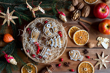 Christmas gingerbread cookies in a round wicker basket on a wooden table