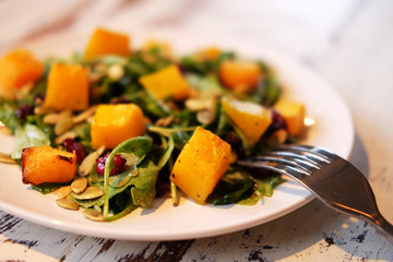 salad with pumpkin, pumpkin seeds and arugula