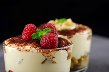Italian dessert tiramisu with fresh ruspberries.