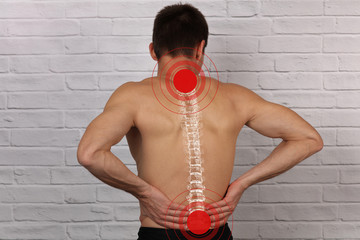 Muscular Man suffering from back and neck pain. Incorrect sitting posture problems, Muscle spasm,...