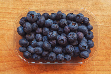 Blueberries myrtilles in plastic container box