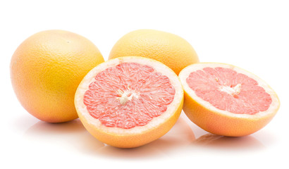 Red grapefruits isolated on white background two whole one cut in half cross section.