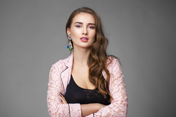 Fototapeta premium Beautiful young woman in pink lace jacket