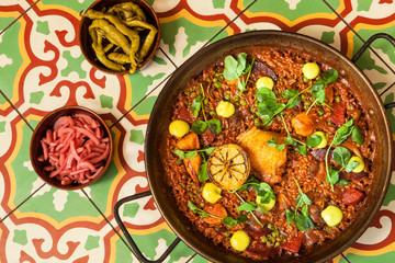 chorizo and pollo paella on a tile tabletop