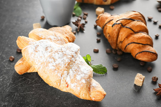 Delicious sweet croissants on table