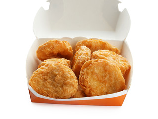 Box with tasty chicken nuggets on white background