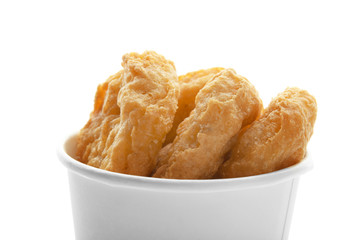 Paper cup with tasty chicken nuggets on white background