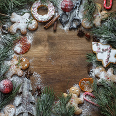Christmas wreath decorated with gingerbread men, dried orange,vanilla sticks,gingerbread sprinkled with powdered sugar